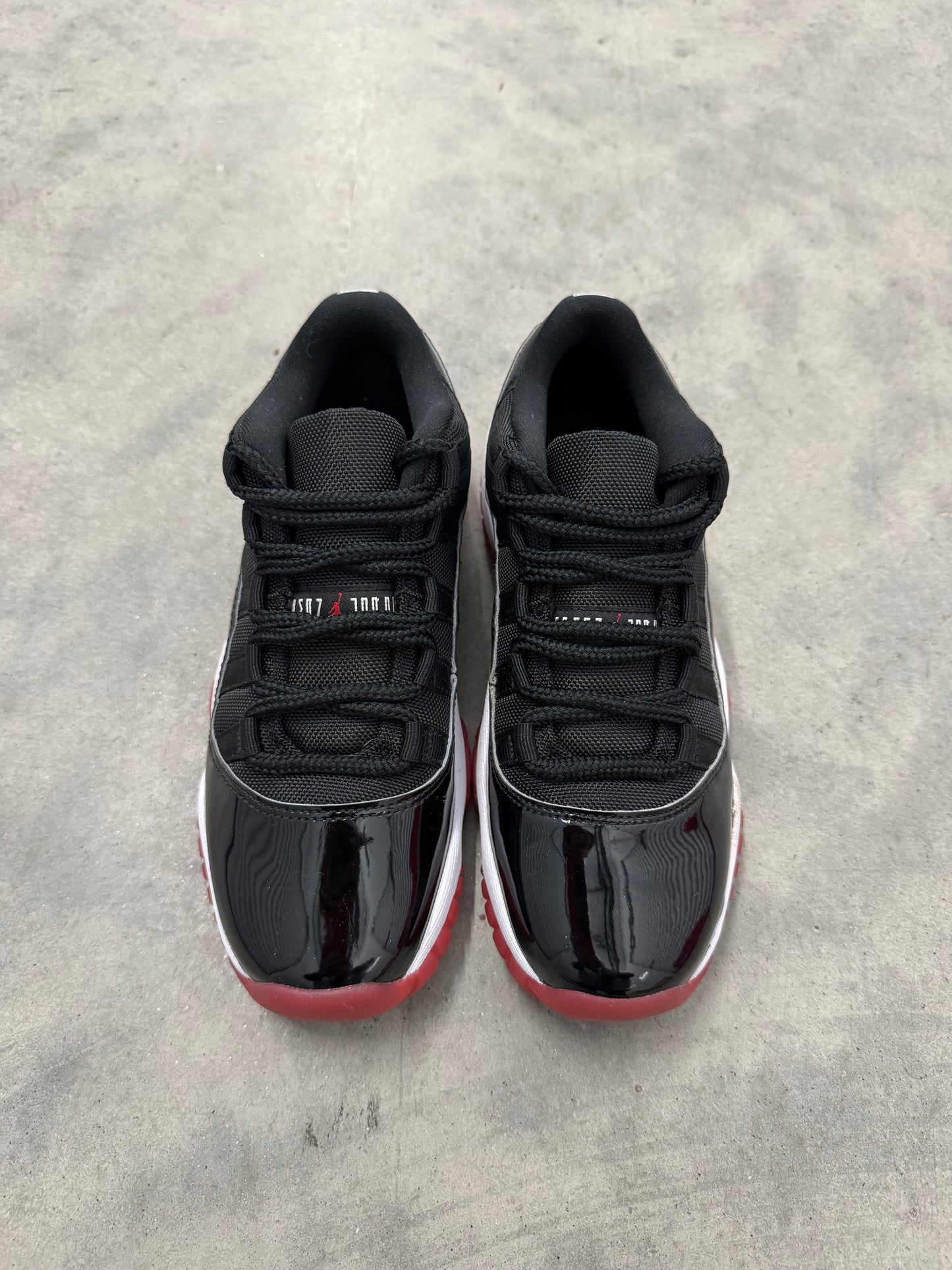 JORDAN 11 LOW “ Bred “