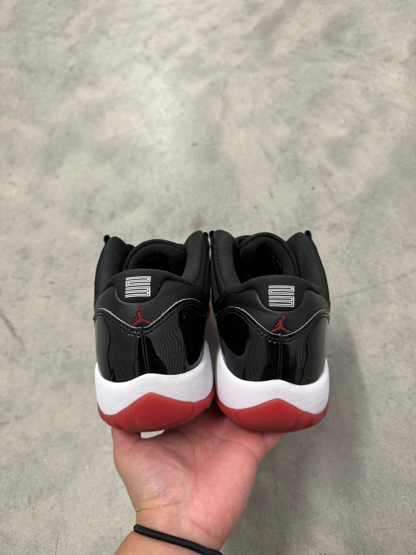 JORDAN 11 LOW “ Bred “