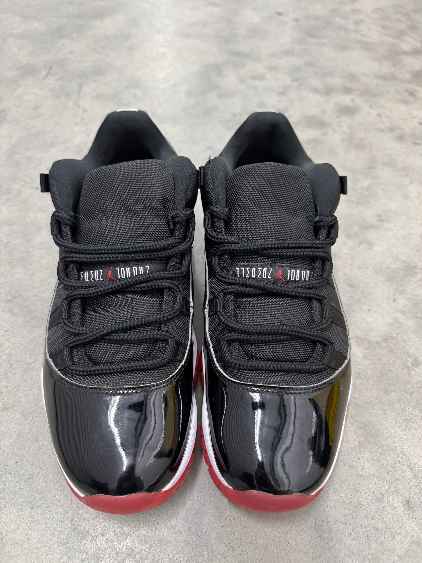 JORDAN 11 LOW “ Bred “
