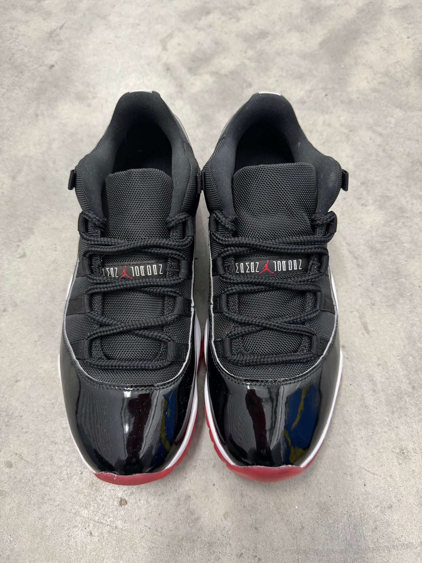 JORDAN 11 LOW “ Bred “