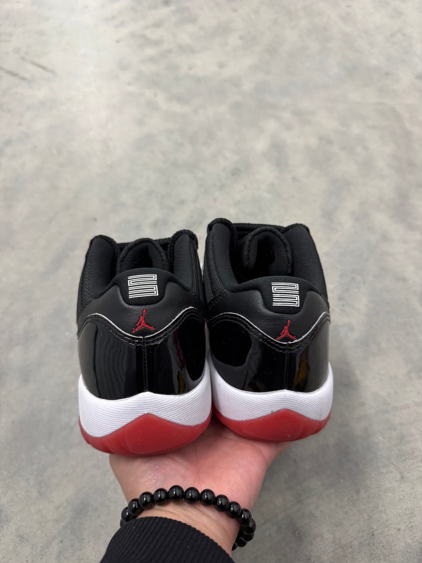 JORDAN 11 LOW “ Bred “
