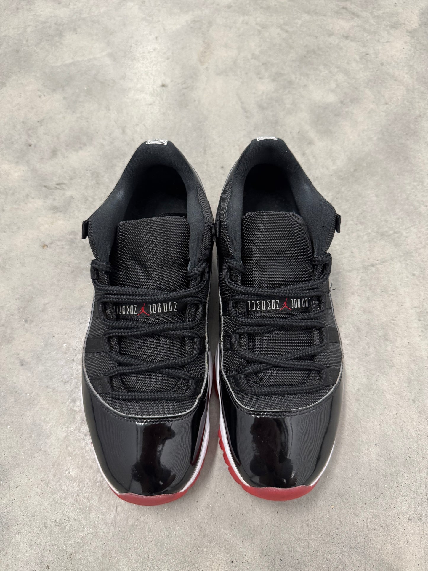JORDAN 11 LOW “ Bred “