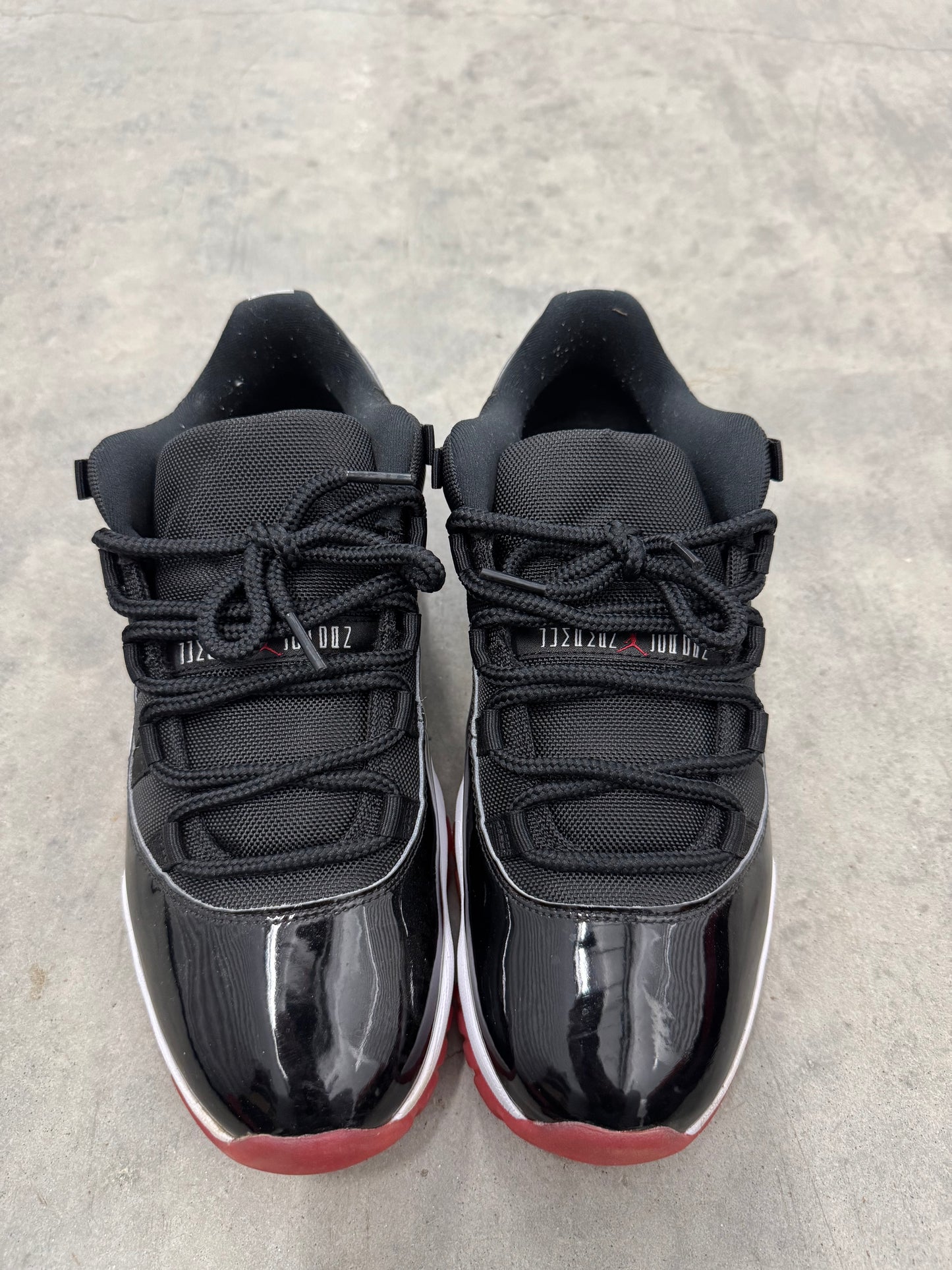 JORDAN 11 LOW “ Bred “